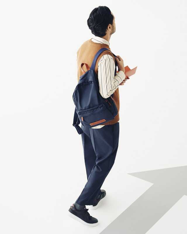 Knitted vest by Steven Alan, shirt by Scye, trousers by Cellar Door from United Arrows, socks by Uniqlo, trainers by Emporio Armani, backpack by Felisi, passport case by Porter