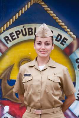 Naval officer Gloria García in front of Colombian colours