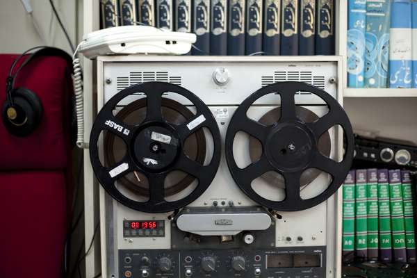 Hebrew and Farsi dictionaries behind a reel- to-reel tape recorder
