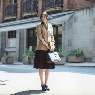 Jacket, skirt, under skirt by Dries Van Noten, shirt, bag by Prada, shoes by Black Fleece by Brooks Brothers, watch by Hermès