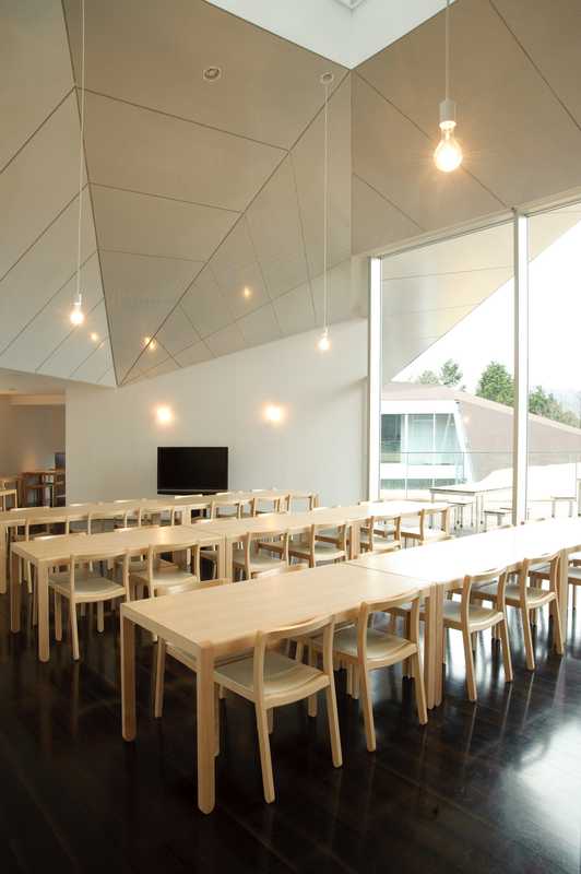 Top-floor restaurant with naked light bulbs and an angular ceiling