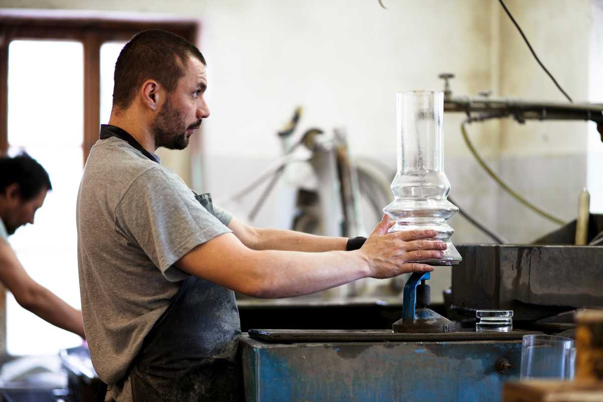 A worker in the polishing workshop checks that a piece is level