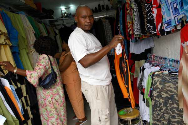 A Congolese man buys Chinese-made clothes
