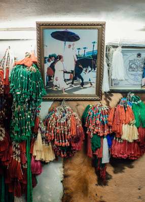 Photograph of Mohammed VI in a traditional saddle shop in the souk in Fes