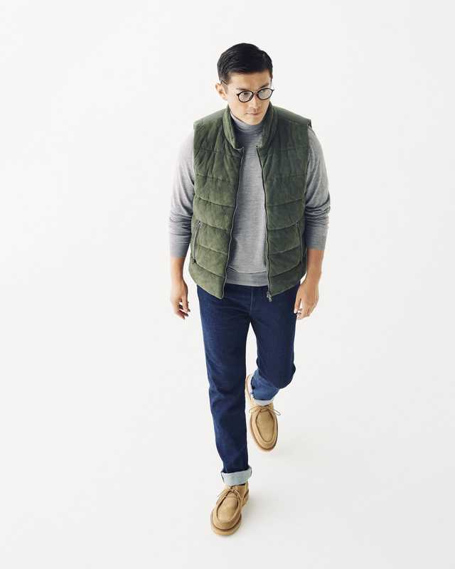 Down vest by Herno, rollneck jumper by Orazio Luciano, jeans by Jacob Cohen, glasses by Ray-Ban