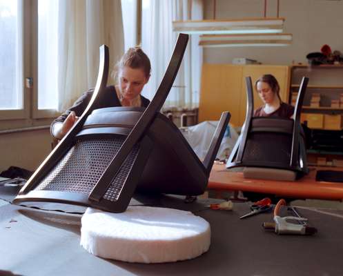 Employees at work in the upholstery department