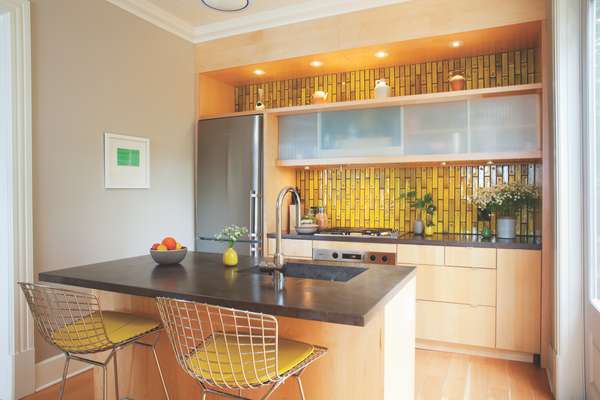 Kitchen with concrete counters and acid-yellow Heath tiles