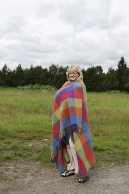 Worker Unni Tomas models a blanket