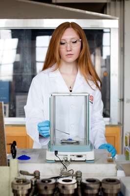 Graduate student weighing YInMn blue for analysis