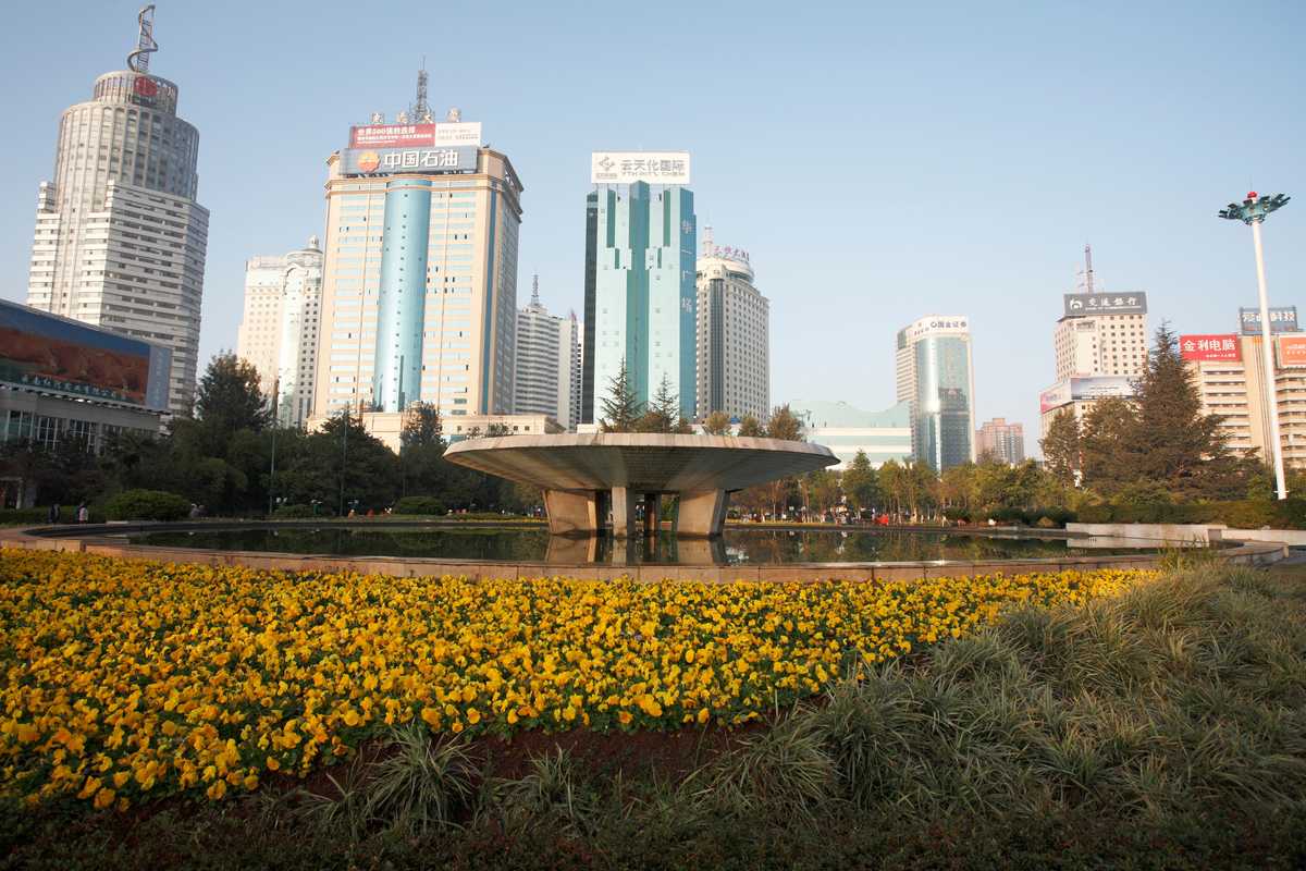 Fountain in Dong Feng Square with downtown Kunming in the background