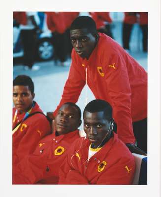 Angolan football players watch the opening ceremony celebrations