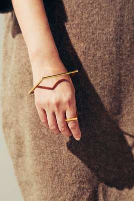 Dress by Sofie D’Hoore,  bracelet and ring by Minimalux