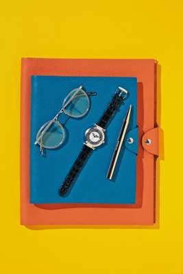 Notebook covers by Hermès, glasses by Oliver Peoples, watch by Chopard, pen  by Minimalux