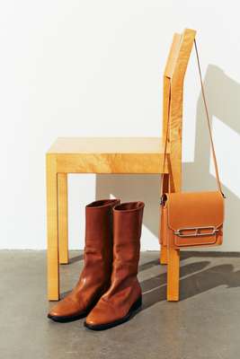 Boots by Saint Laurent by Anthony Vaccarello, bag by Hermès, chair by Nikari