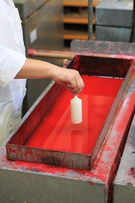 Dipping the pillar candles into dye
