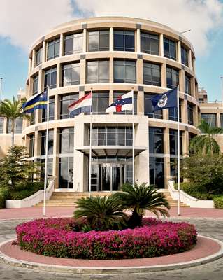 The bank, with flags of Curaçao, the Netherlands, Netherlands Antilles, and the central bank’s crest