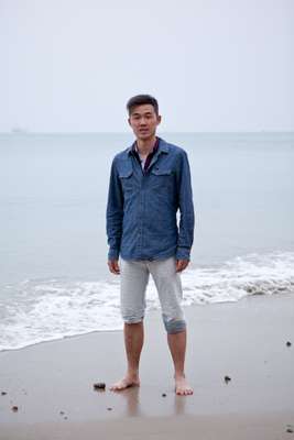 Tony Zhao on the beach in Sanya, visiting from Shanghai