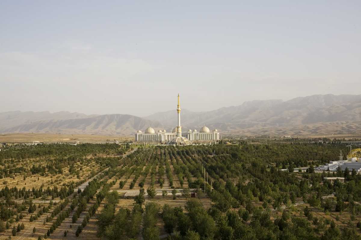 The monument to the independence of Turkmenistan across Independence Park. Behind are the Kopet Dag mountains, the border with Iran 