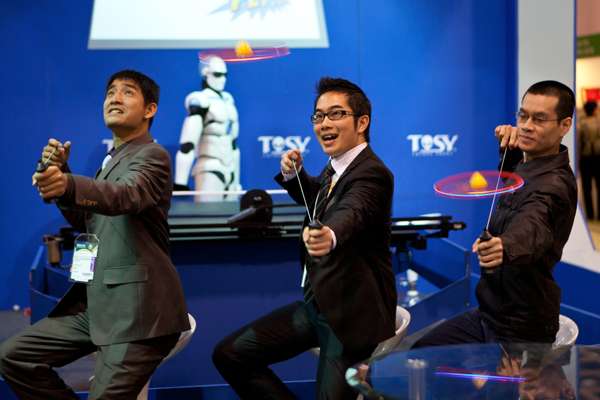 Representatives from Vietnamese company Tosy demonstrate a product