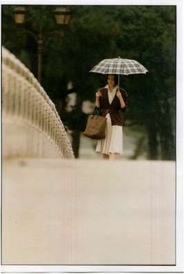 Dress by Salvatore Ferragamo, cardigan by Fendi, bag by Bottega Veneta, umbrella by Traditional Weatherwear