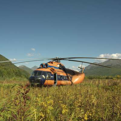 A helicopter unloads fishermen in the Kamchatkan countryside