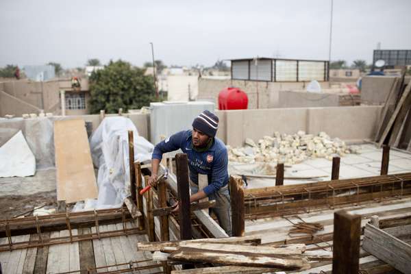Assan Alawi helps build new houses in the Amil district of Baghdad