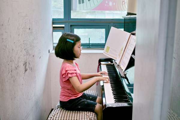 Cho Yun-je, eight, plays the piano