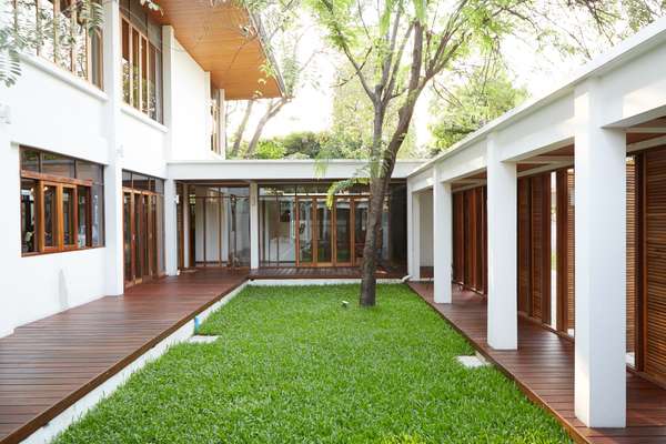 Enclosed lawn in  the home of Chat  Architects founder  and director Chatpong Chuenrudeemol
