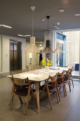 The reception/café area with chairs by Hans Wegner and lighting by Sector
