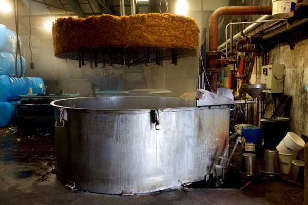 Wool is loaded by hand into dying vats and then hand fed into a machine that wrings and dries it