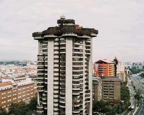 The building fans out at the top, providing a platform for a rooftop terrace and pool