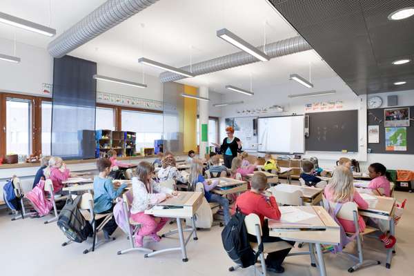 Flip-top beech and steel desks from Finnish company Martela are used in the classrooms