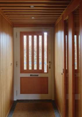 Mobile shades act as wooden peepholes in the front door