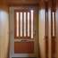 Mobile shades act as wooden peepholes in the front door