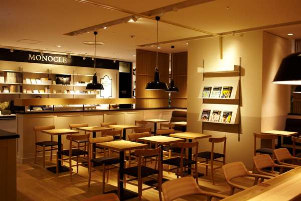 The Monocle Café and Shop interior contains hand-picked furnishings including beech and birch chairs designed by Naoto Fukasawa and Jasper Morrison for Hiroshima-based Maruni Wood Industry and Bolichwerke lampshades