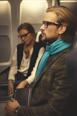 Glasses by Claire Goldsmith, scarf by Hermès, jacket by Caruso, passport case by Smythson