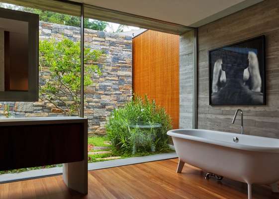 The bathtub and glass wall reveals all in the main bathroom