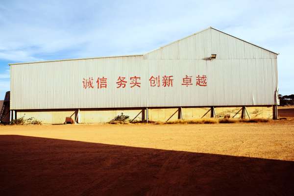 A shed emblazoned with Beidahuang Group's motto: 'Integrity, pragmatic, innovation, excellent'