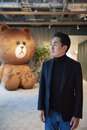 Line CEO Takeshi Idezawa, flanked by a giant version of Brown