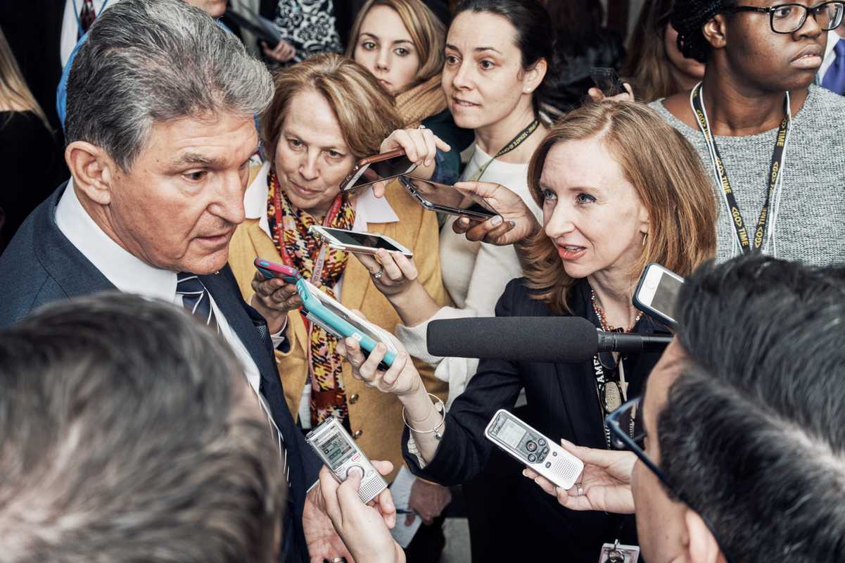 Political correspondent Lisa Desjardins interviewing Democratic senator Joe Manchin outside the US Senate Chamber