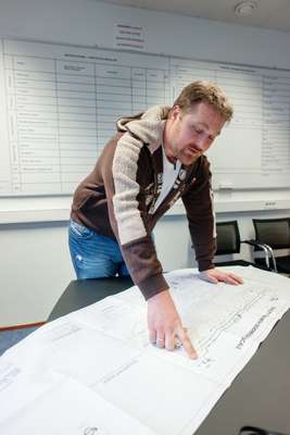 Chief officer Aslak Skripeland reviewing the blueprints of the 'Eagle Barents'