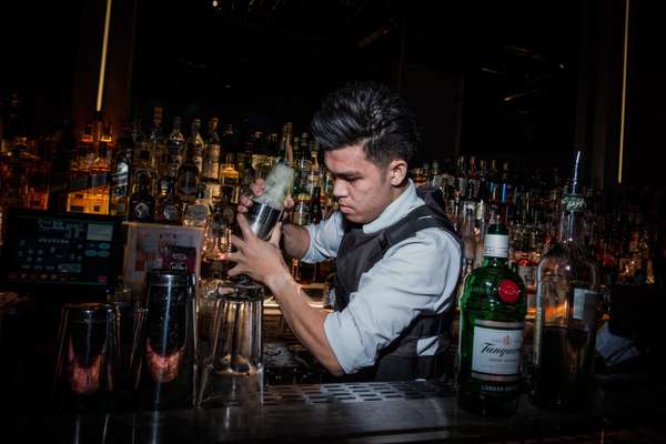 Unusual barman attire: a bulletproof vest 