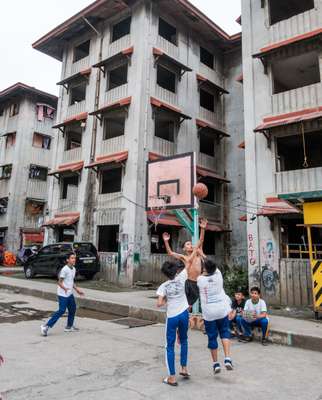 School children playing next  to unfinished housing projects in Makati City