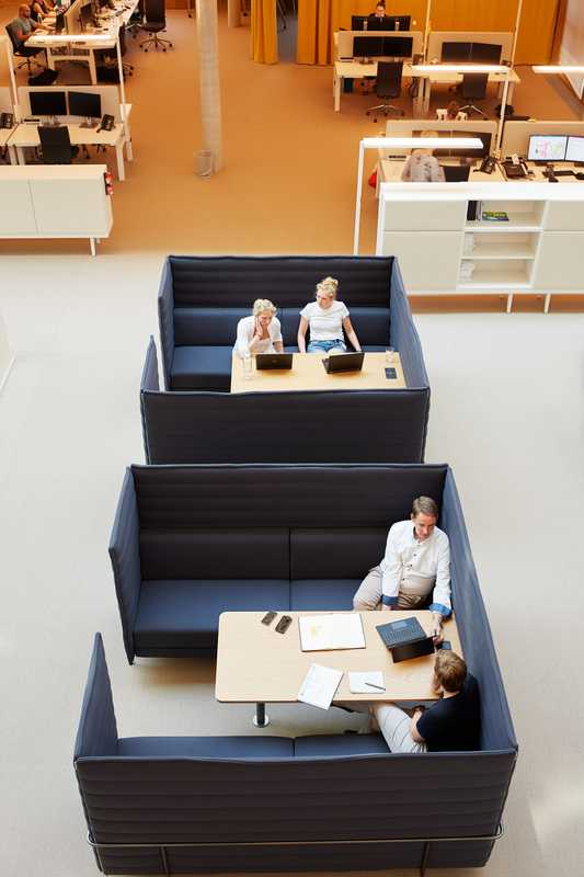 Staff meet in comfort on Vitra high back sofas designed by Ronan and Erwan Bouroullec 