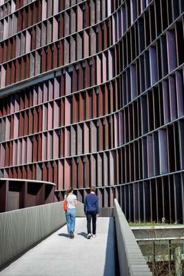 Pedestrians get close to the tower’s undulating façade