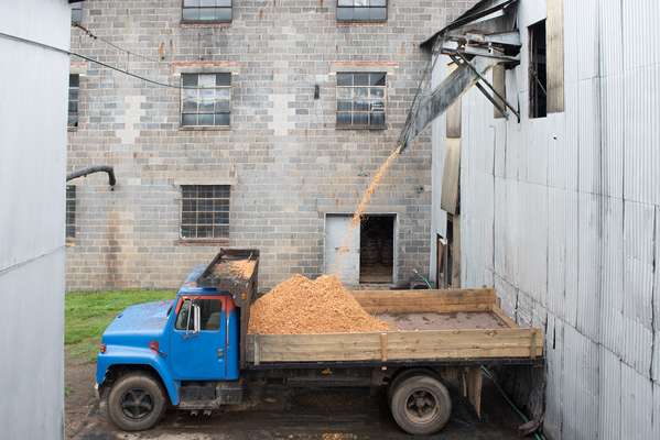 Filling up a lorry with pomace for delivery to nearby farms