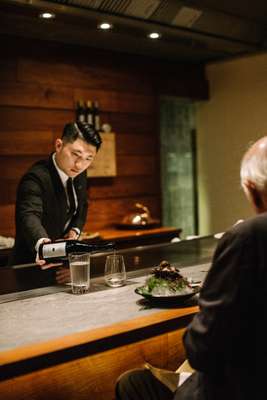 Pouring a glass of Masuizumi Platinum Nama saké