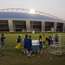 Students after evening football practice. The Aspire Dome is in the background