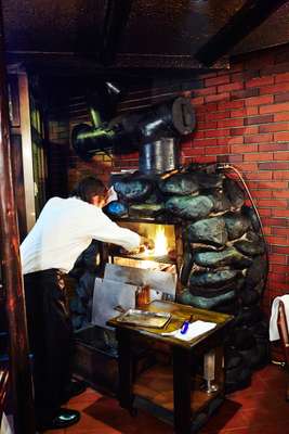 Steaks being cooked on charcoal grill