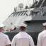 US Navy personnel greet the ‘Freedom’ in Singapore